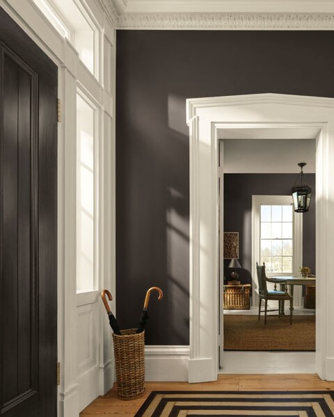 A hallway painted in Silhouette AF-655 on the walls. Ornate cornice and door frames are painted in Swiss Coffee OC-45.