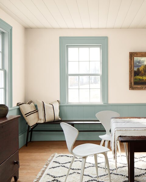 A dining room with lower walls and window frames painted in Raindance 1572 and walls and ceilings painted in First Crush CSP-310.