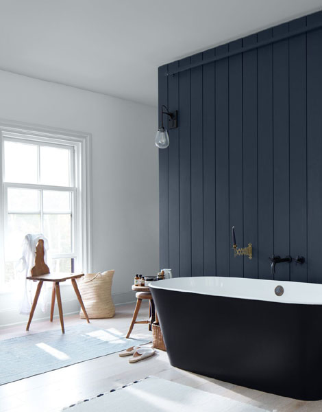 A bathroom with a freestanding bath adjacent to a panelled wall painted in Evening Dove 2128-30. A large georgian sash window and rear wall are painted in Lily Whit2 2128-70.