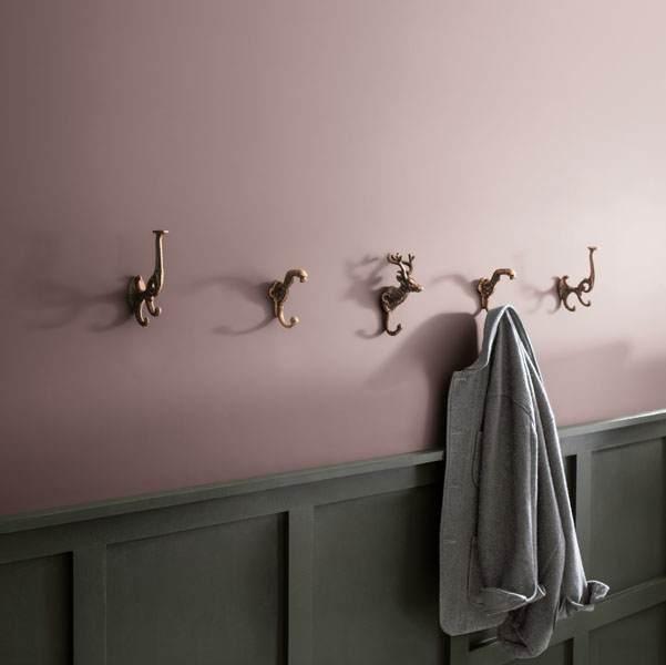 A panelled hallway with upper wall painted in Cinnamon Slate 2113-40 and panelling painted in Ashwood Moss 1484. A jacket hangs on novelty animal hooks.